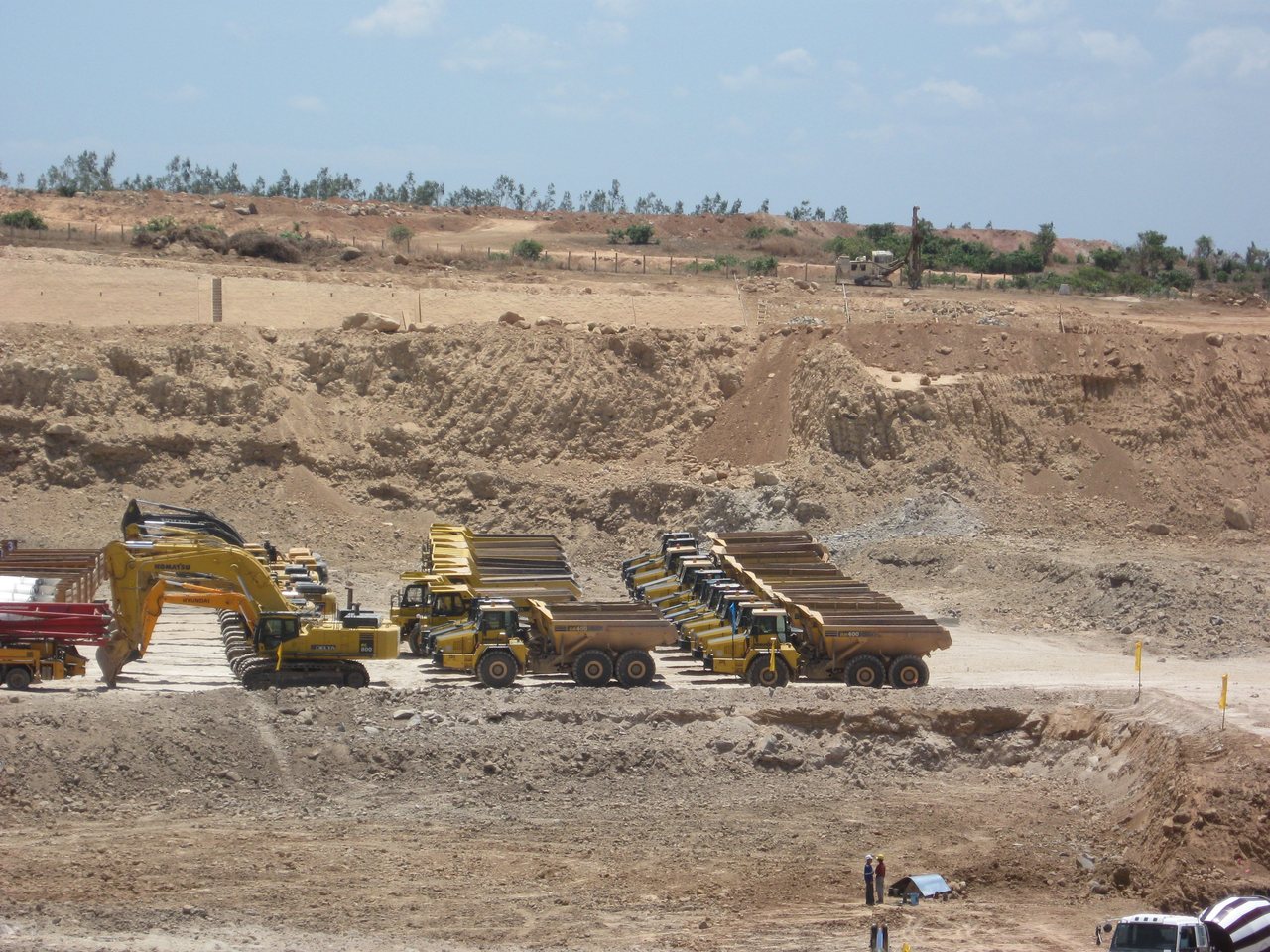 Excavators and dump trucks staged for deployment